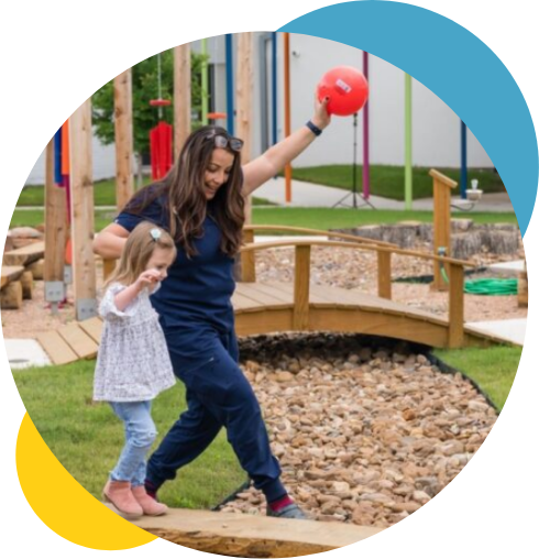 Brighton Center Therapist Playing with Young Girl in Brighton Center Courtyard