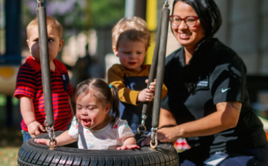 Brighton Center Teacher Playing with Children