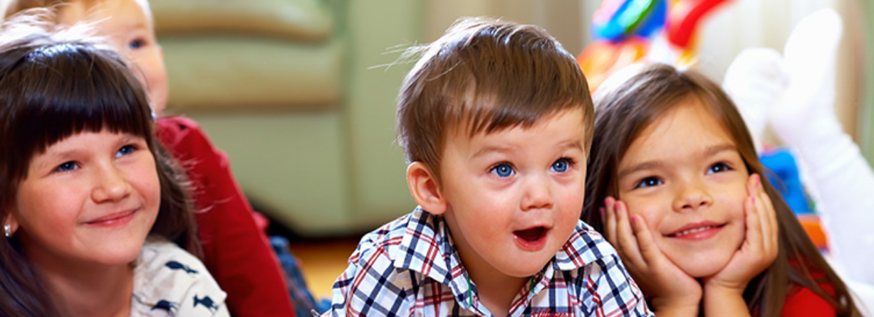 Surprised Young Boy with other Young Children