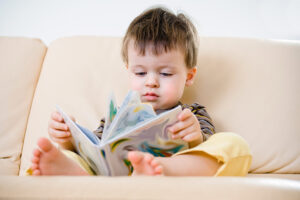 Young Boy Developing Language Skills by Beginning to Read